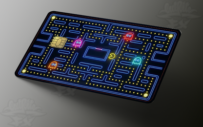 Vinyl credit card skin featuring a glowing neon retro arcade maze design with colorful ghosts and a yellow character.